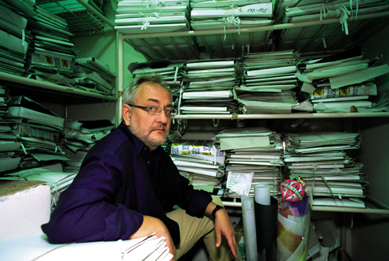 Producer Tomasz Filipczak with stacks of EDEN production papers